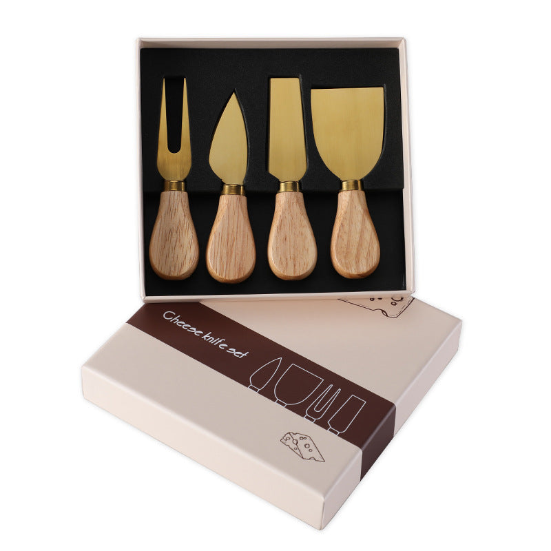 Gold 4-piece cheese knife set in open gift box with wooden handles
