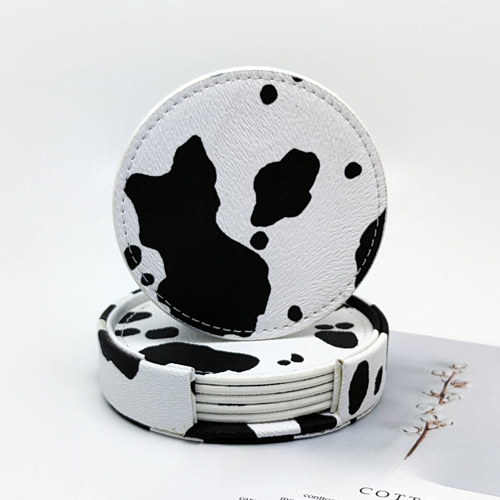 Classic cow print leather coaster, round design with white background and black spots