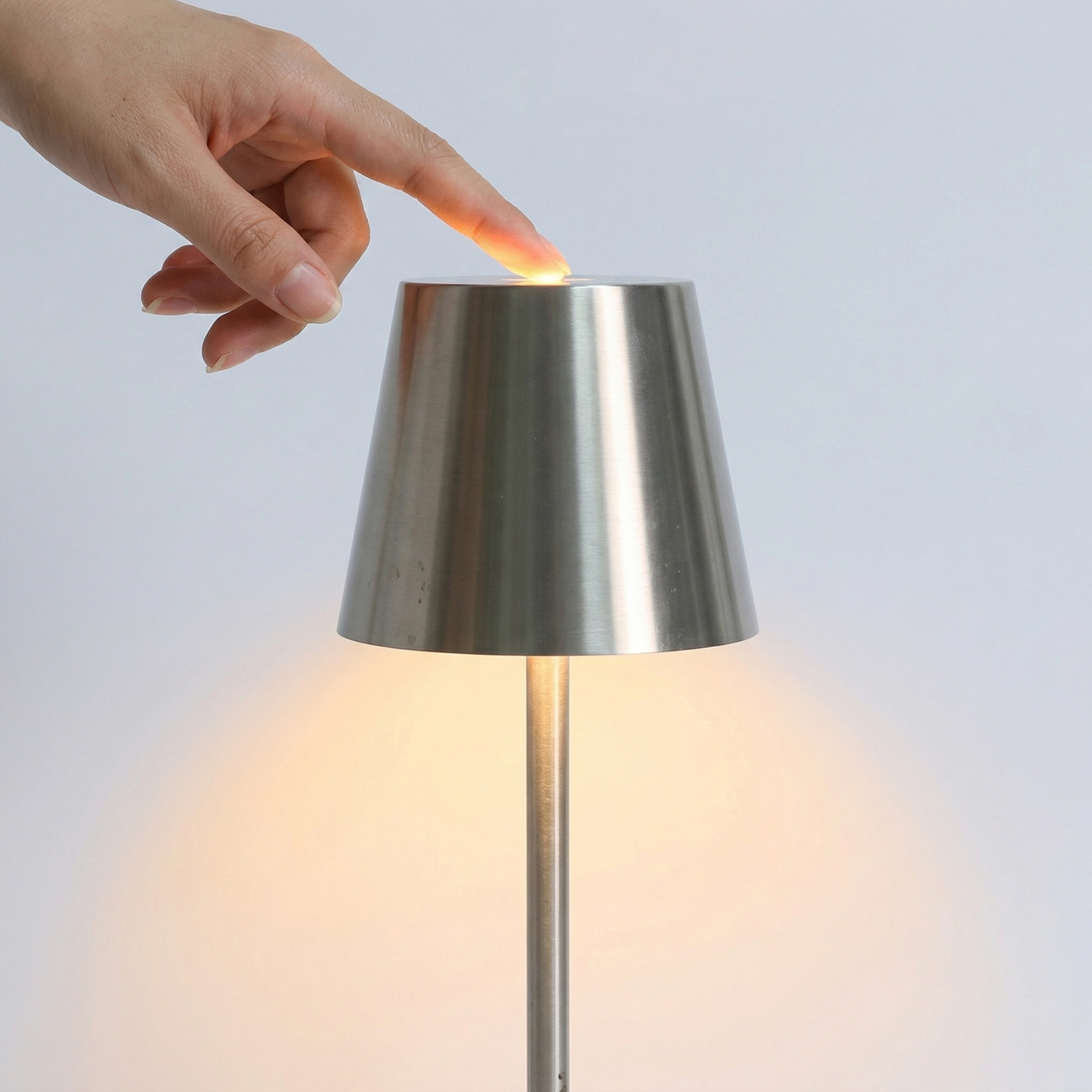 Silver rechargeable LED table lamp with touch top control, warm glow lit