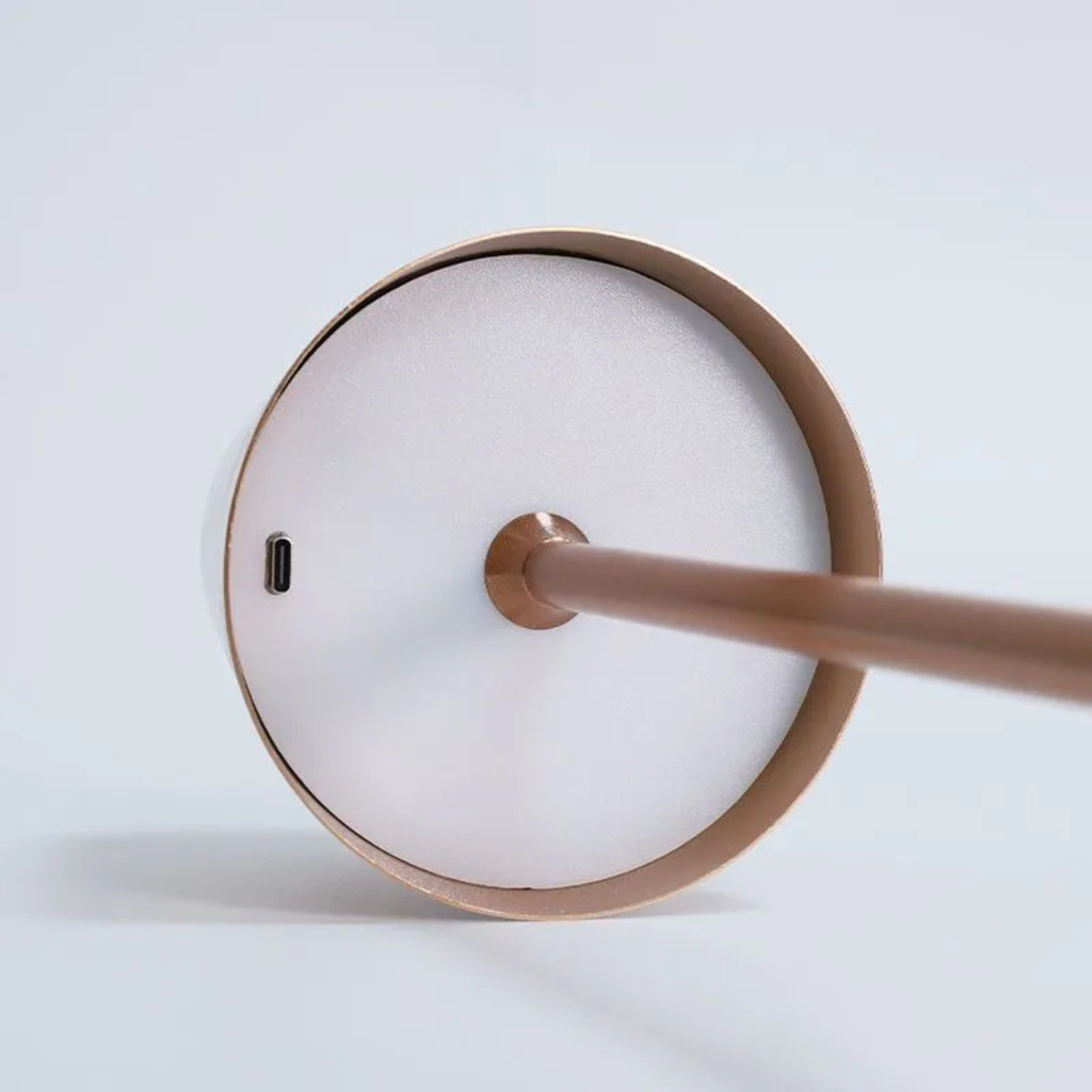 White lamp base close-up with charging port and touch control element.