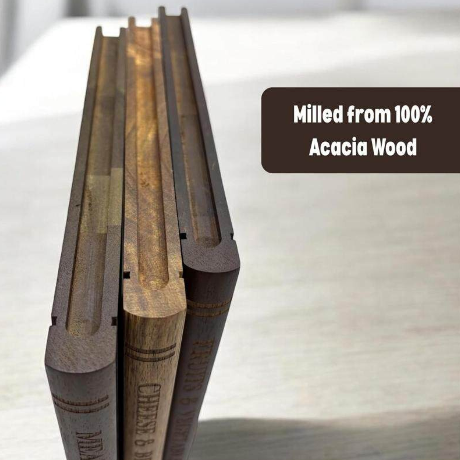 Close-up of acacia wood cutting board spines and stand, dark and light panels