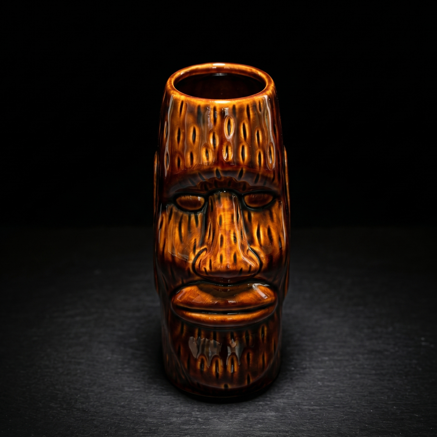 Amber ceramic tiki mug with moai face design, front view