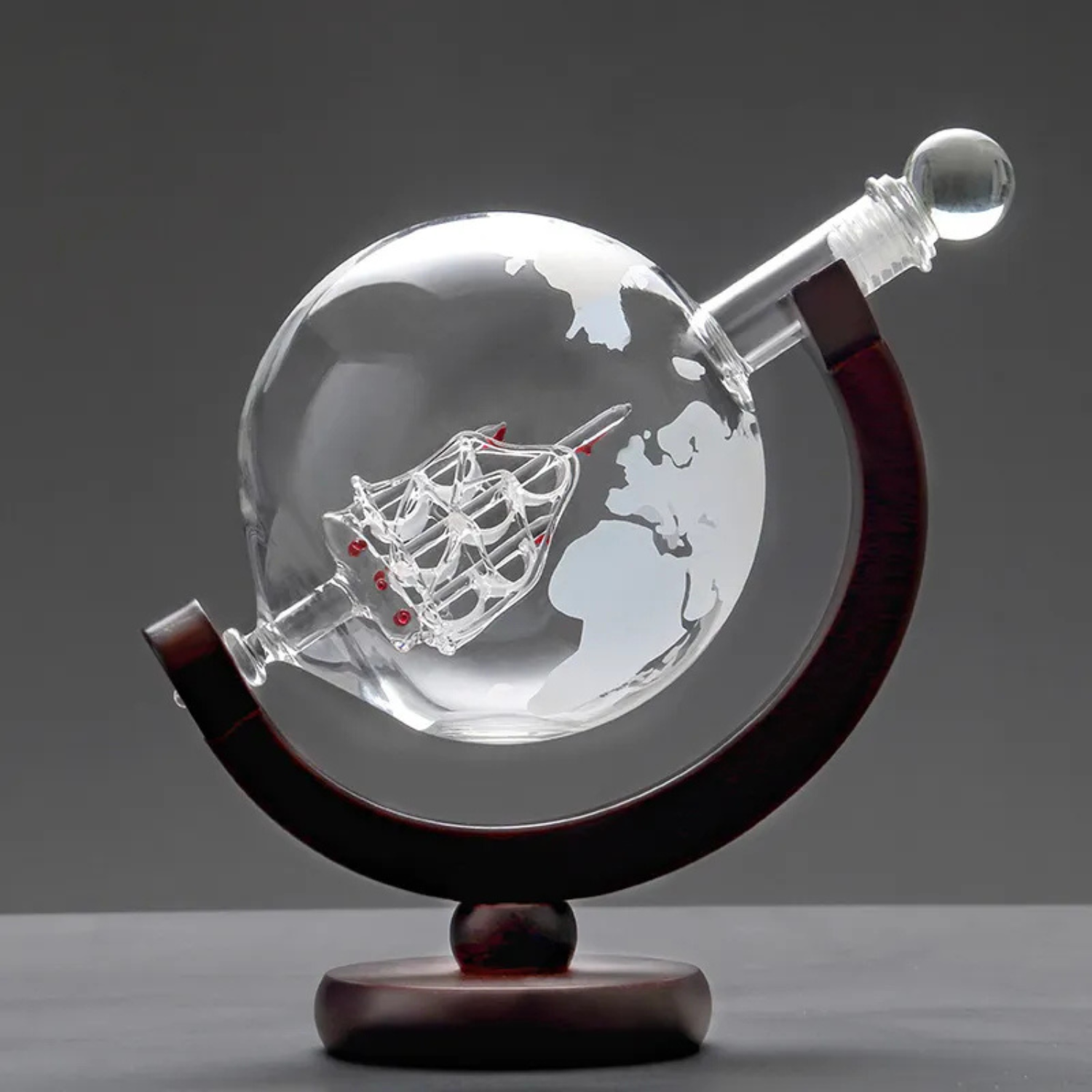 Decorative object with glass sphere and wooden base on a dark background
