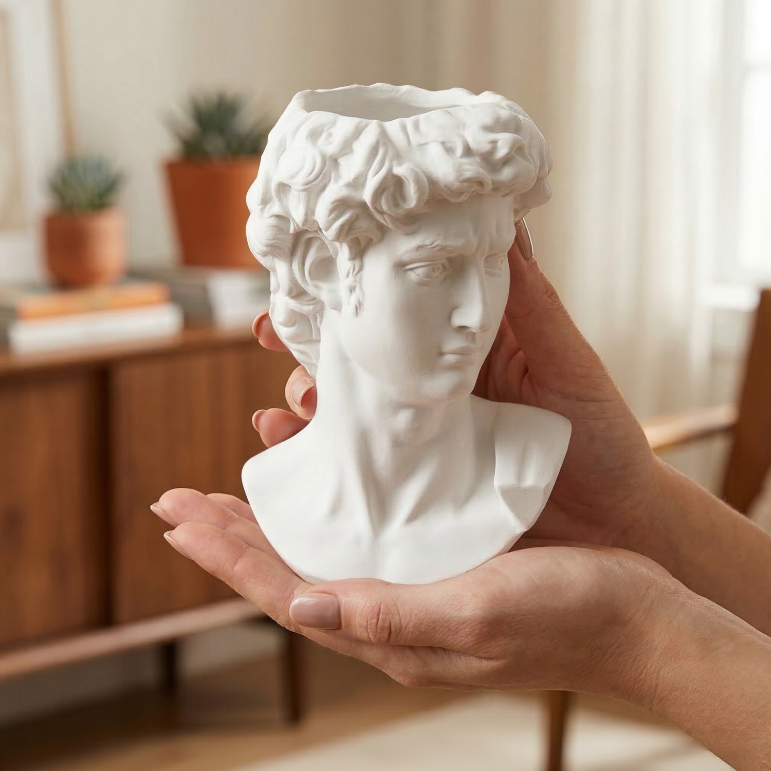 White Greek David bust vase in hand, close-up of sculpted head and shoulders