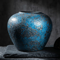 Blue crackle-glaze ceramic vase, close-up front view of cracked glaze