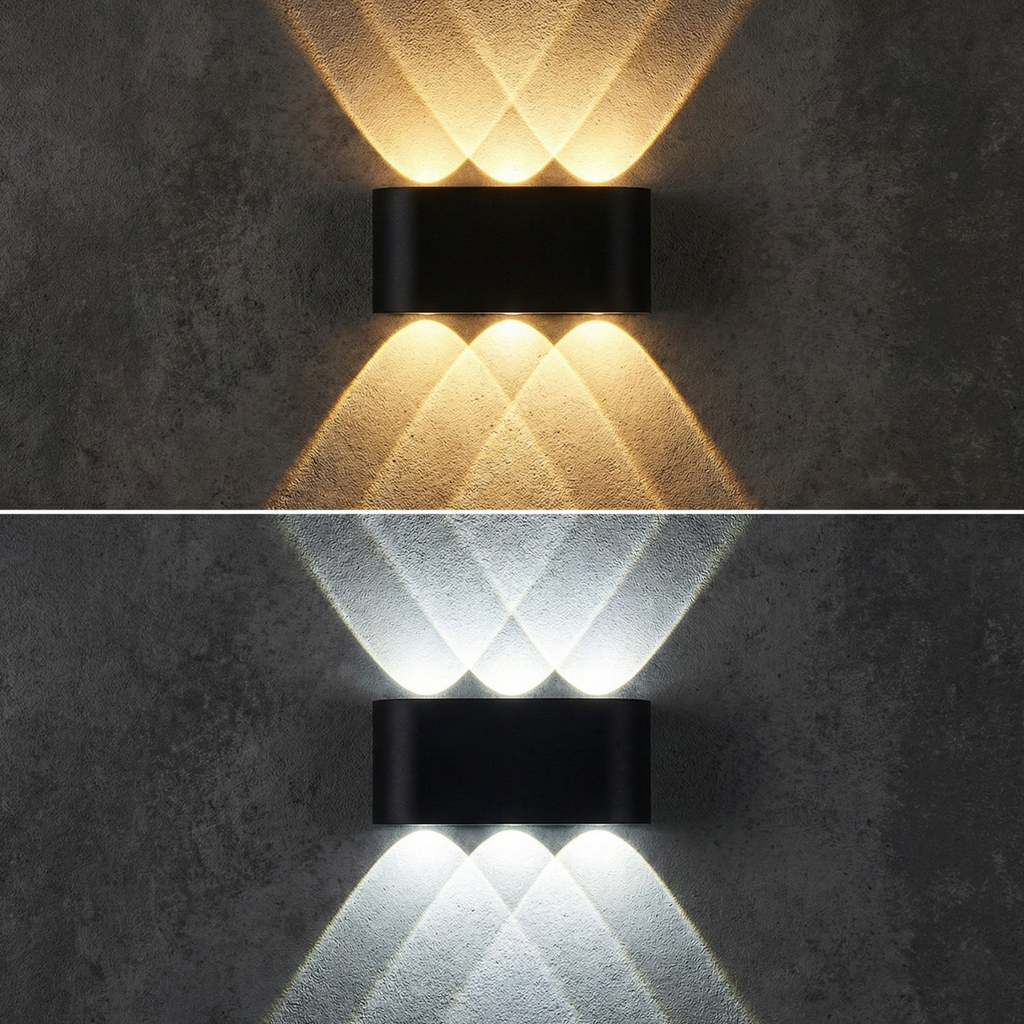 Close-up LED up-down wall sconce emitting warm white light, black brackets