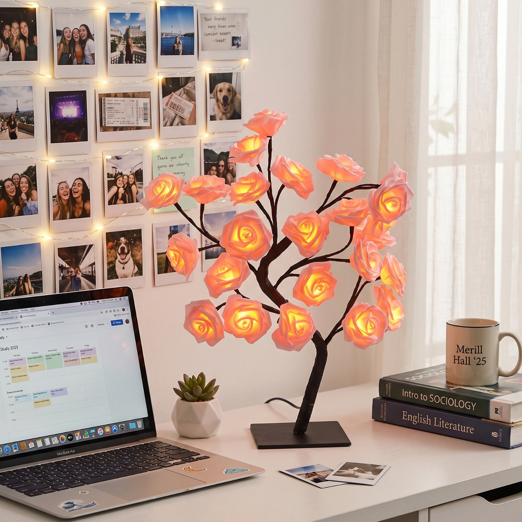 Decorative LED tree lamp on a desk with a laptop, books, and mug in the background.