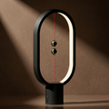 Black oval LED table lamp with floating switch ambient night light