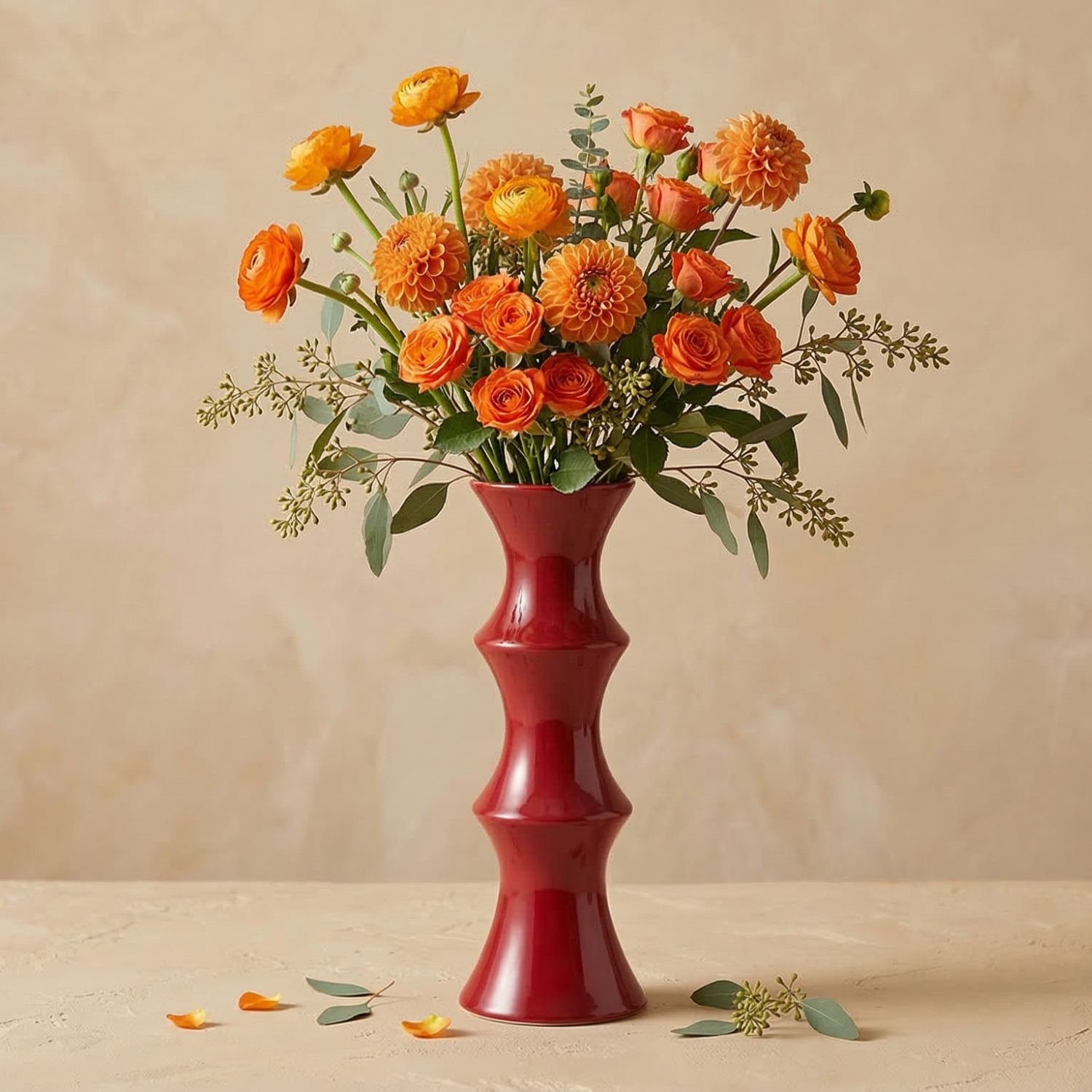 Red vase with orange flowers on a beige background