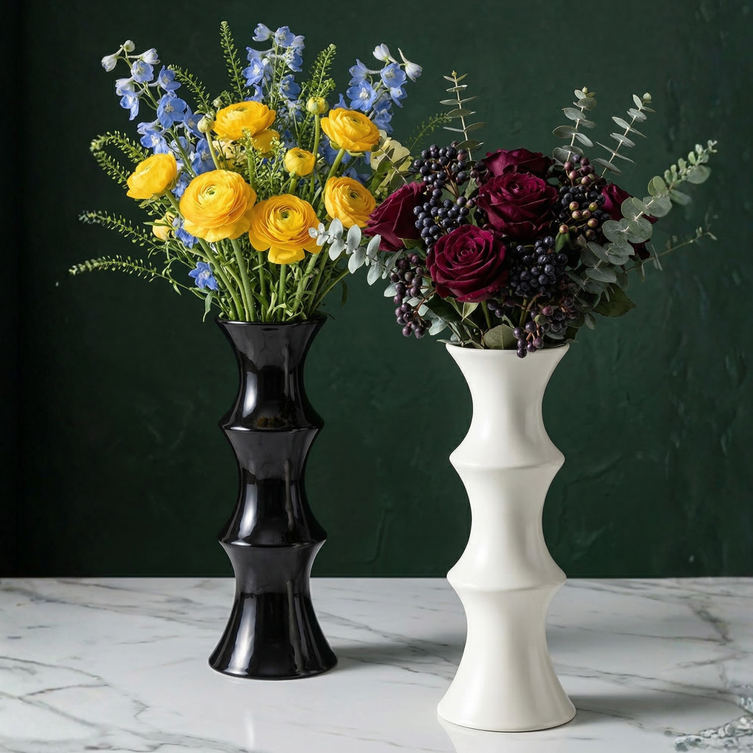 Two flower bouquets in a black and white vase on a marble surface with a dark green background.