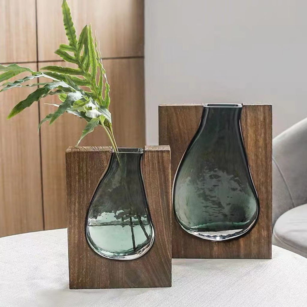 Pair of green glass teardrop vases on wood block bases