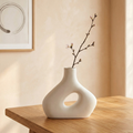 White ceramic sculptural vase with hollow oval opening, minimalist design