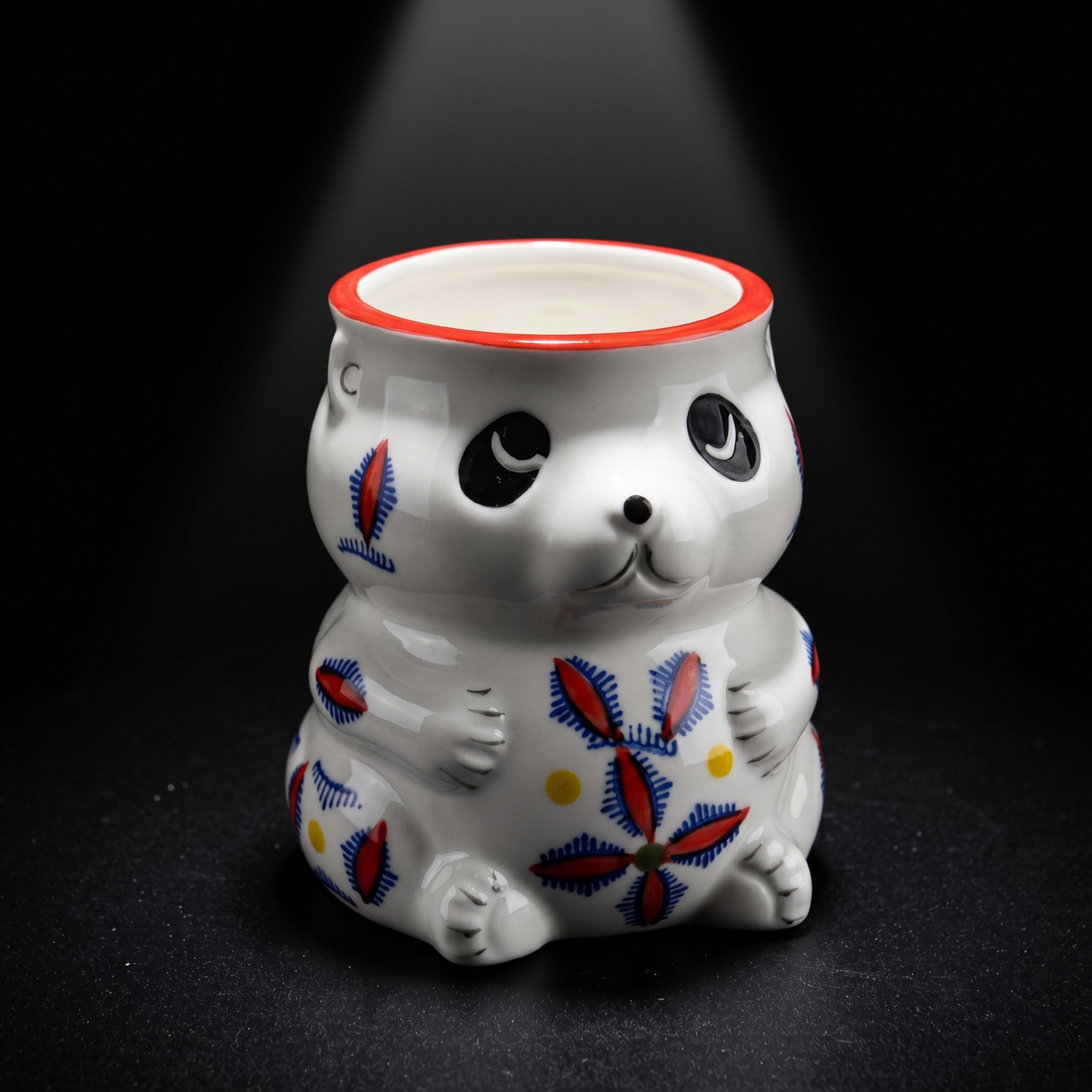 Panda tiki mug close-up, white ceramic with blue/red floral pattern and red rim