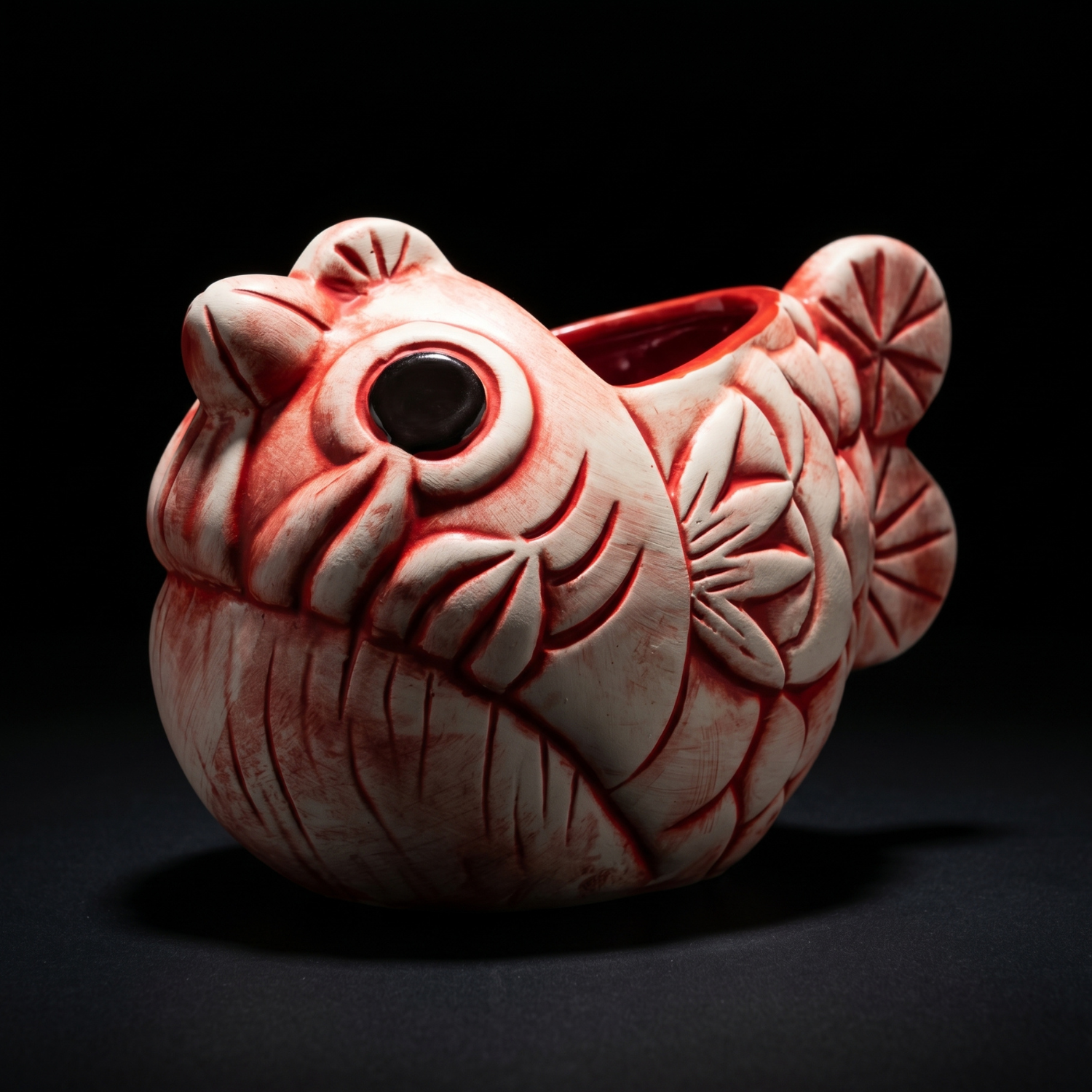 Red-and-white ceramic fish tiki mug with carved face and open eye