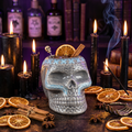 Gray pirate skull tiki mug with ice, orange slices and cinnamon stick