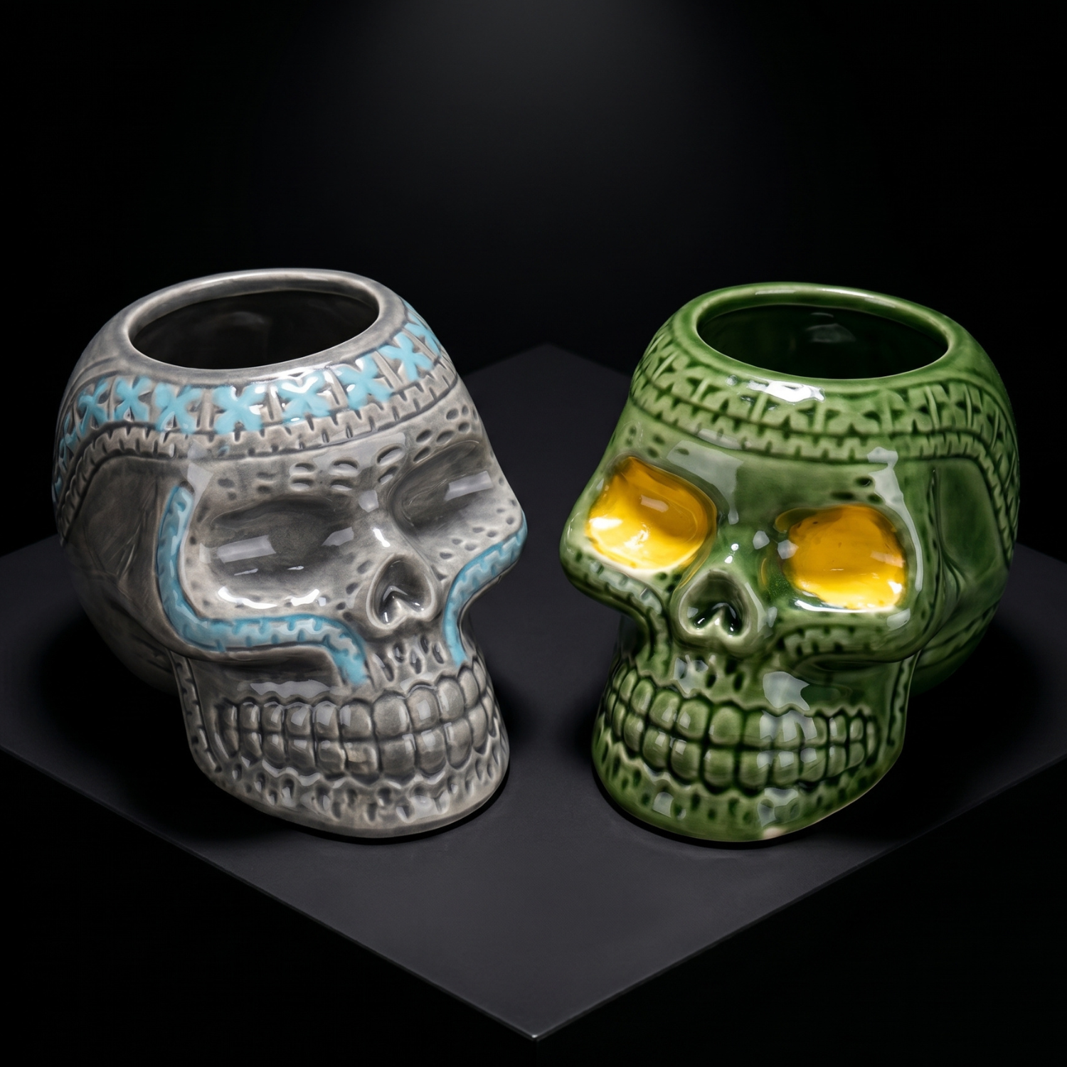 Gray and green pirate skull ceramic mugs with open mouths and yellow eyes