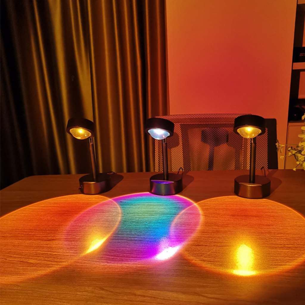Three small table lamps casting colorful shadows on a wooden surface.