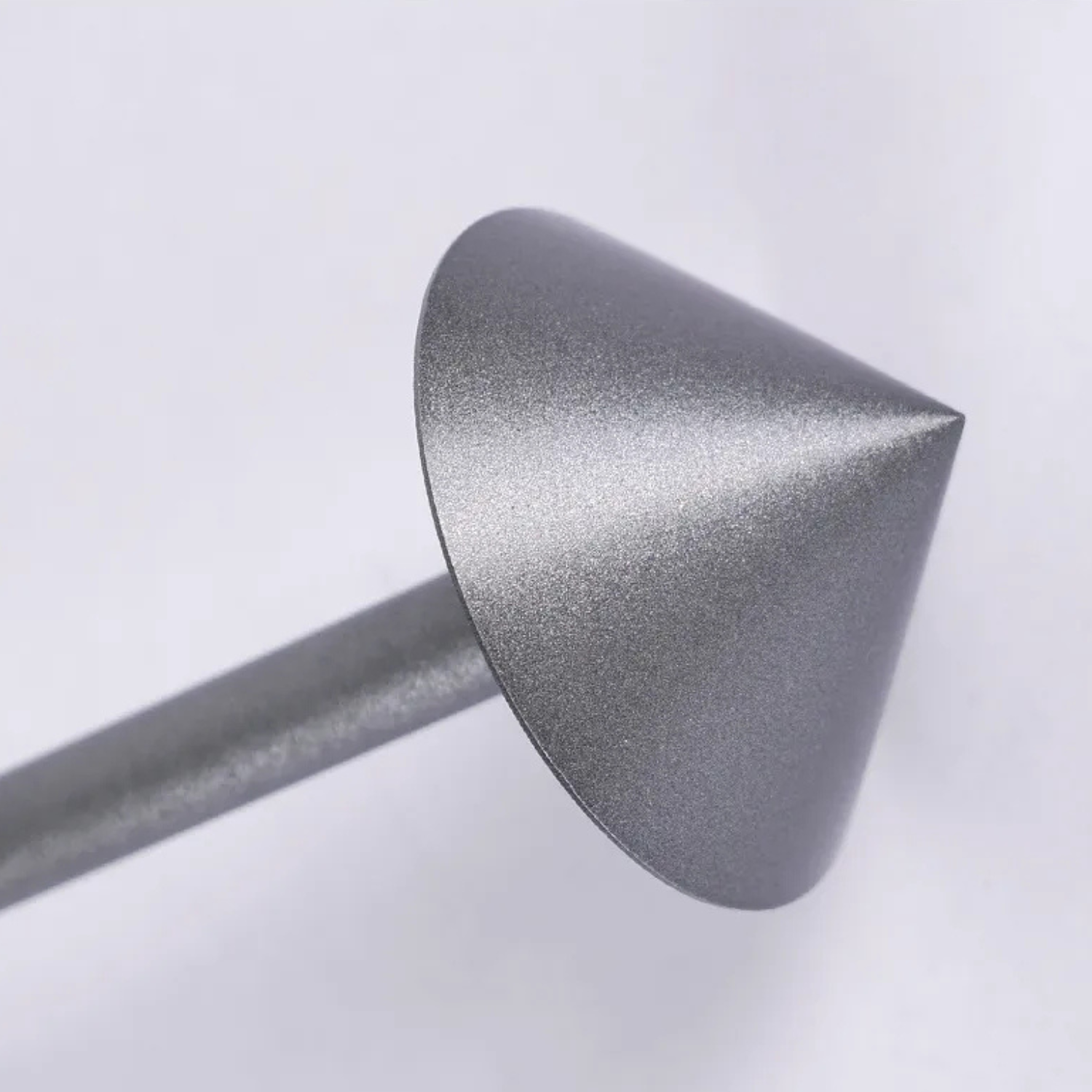 Metallic cone-shaped object on a white background