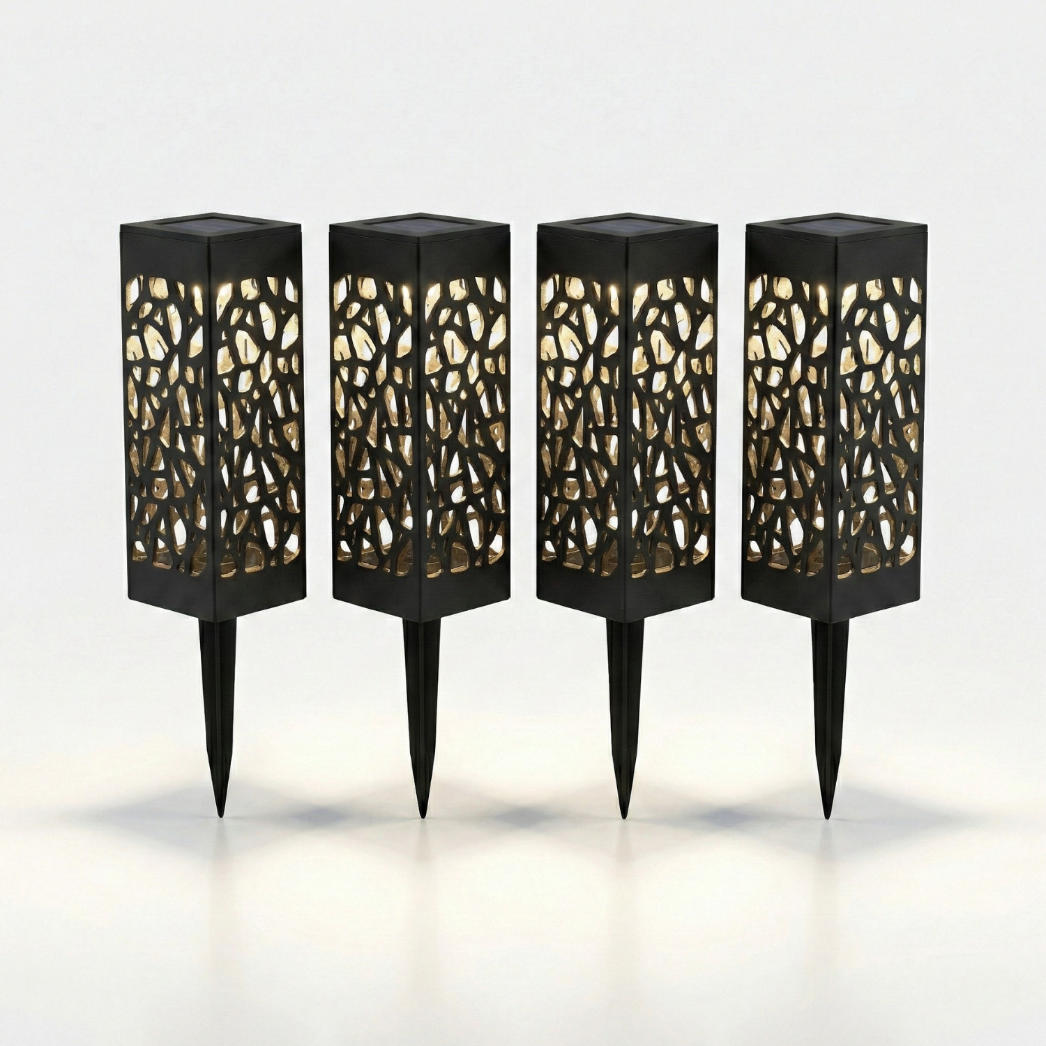 Four black outdoor lamps with decorative cut-out designs on a white background