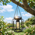 Single solar hanging outdoor lantern with warm white glow, dark iron cage, chain