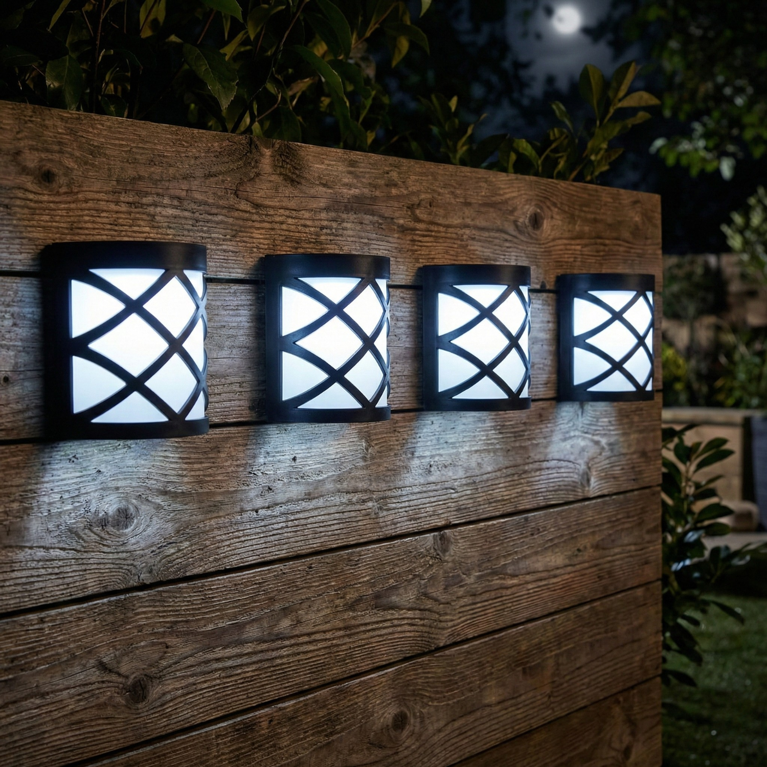 Four outdoor wall lights with lattice design on a wooden panel at night.