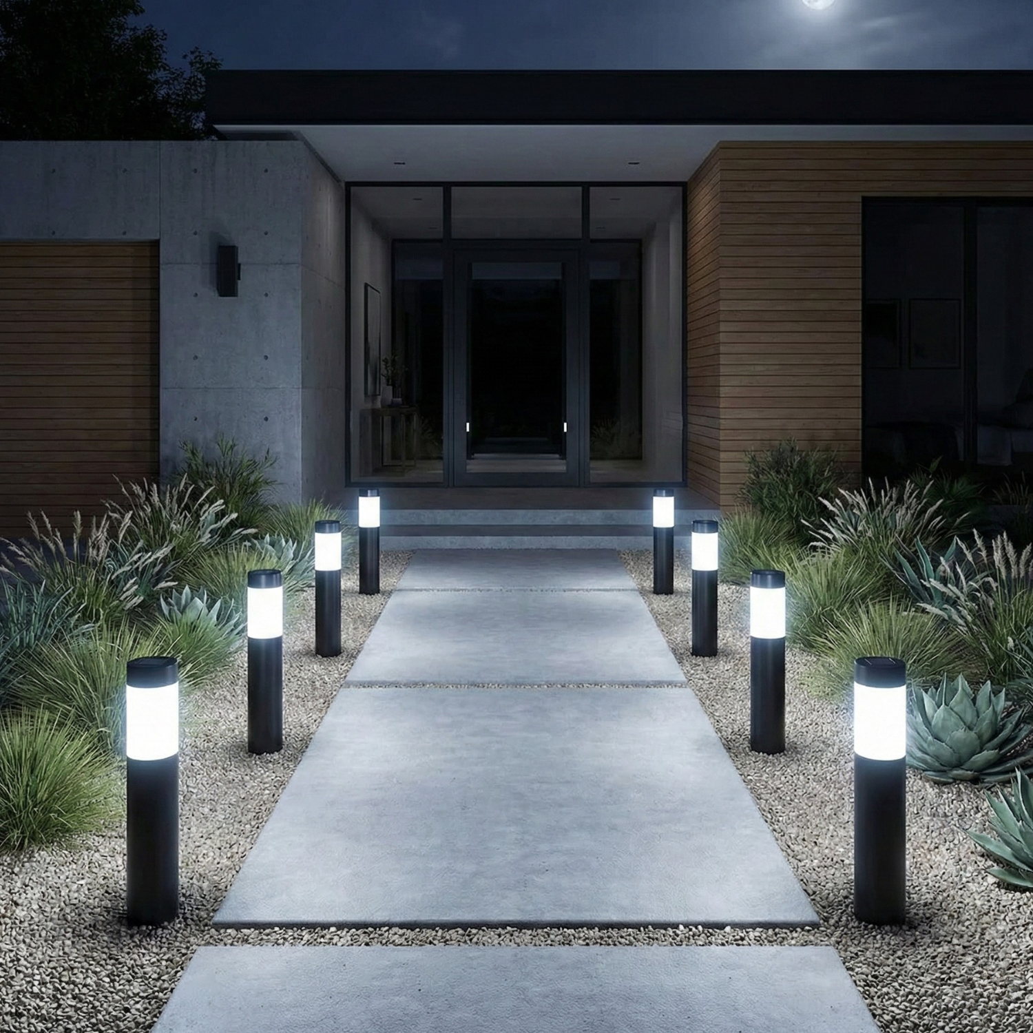 Black solar bollard lights with warm LED glow lining an outdoor path