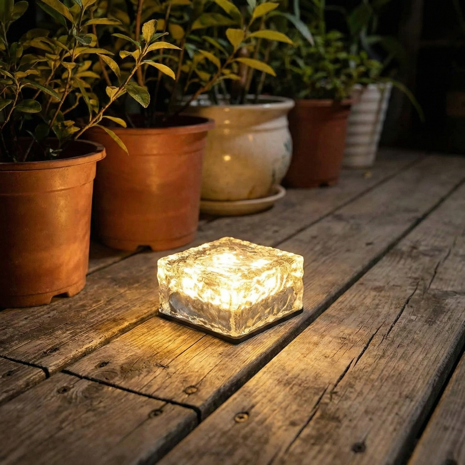 Solar ice brick garden lamp, warm white glowing glass cube on patio