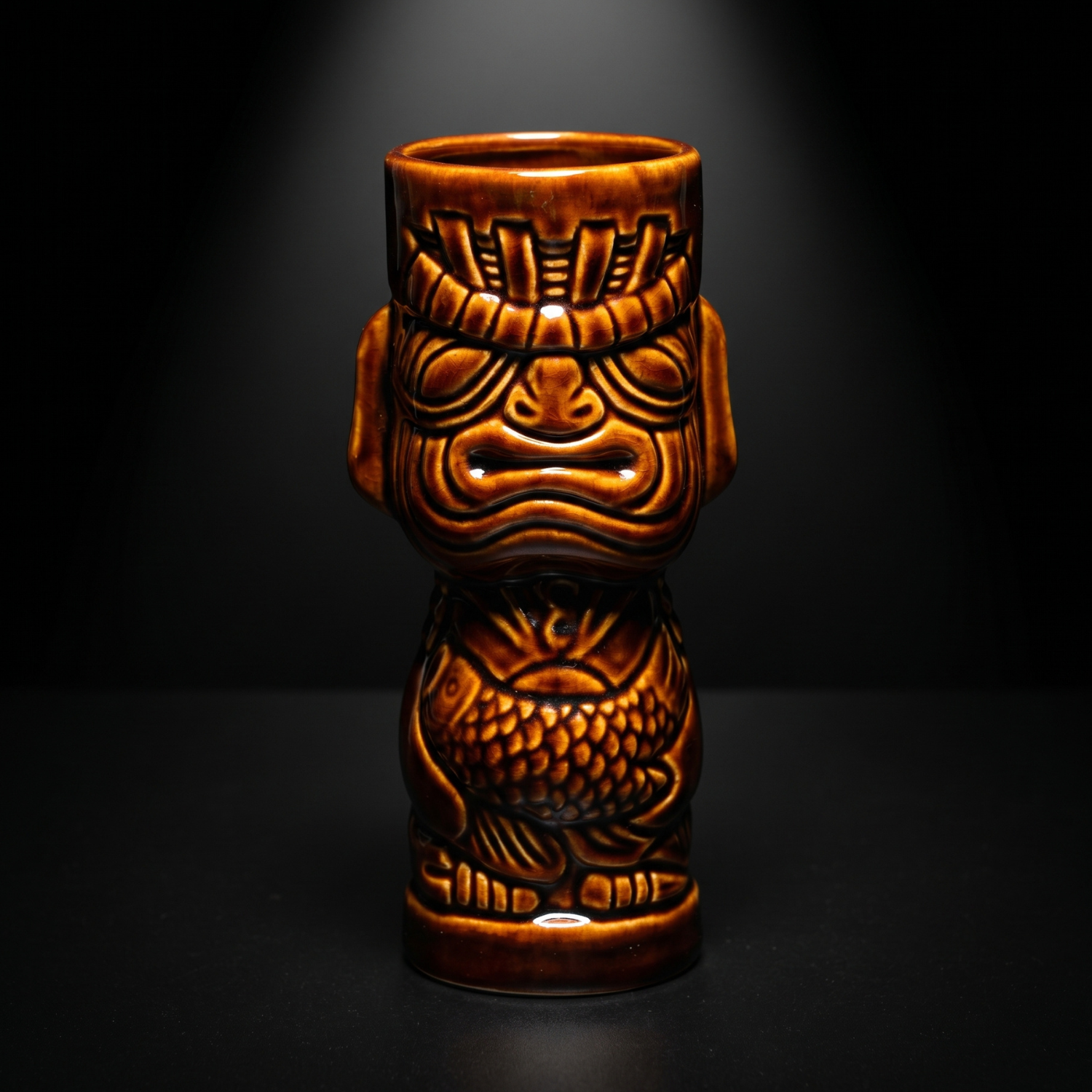Tiki mug with tribal design on a black background