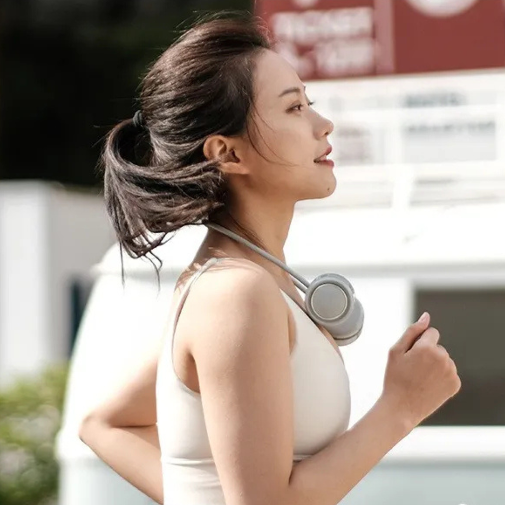 Woman wearing a white tank top with a blurred background