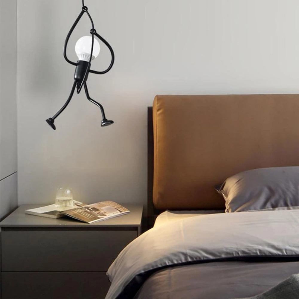 Modern bedroom with a unique pendant light fixture above a bed.