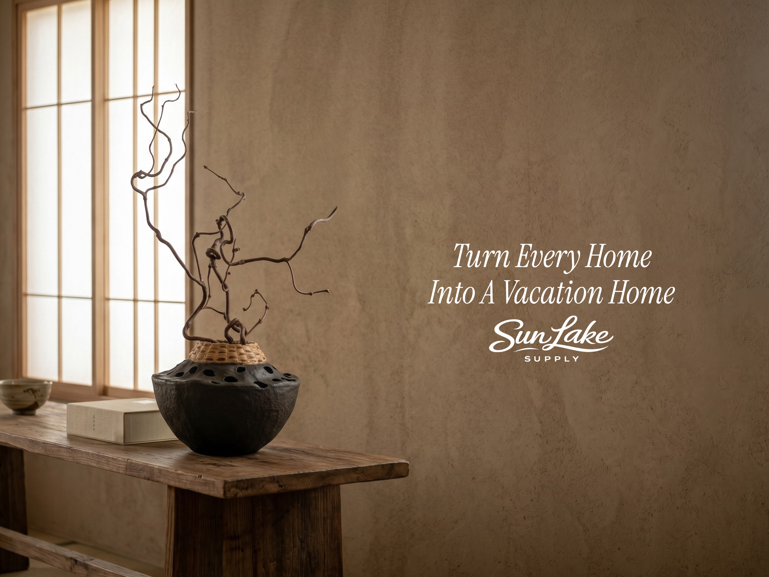 Decorative pot with branches on a wooden table against a beige wall with SunLake Supply branding.