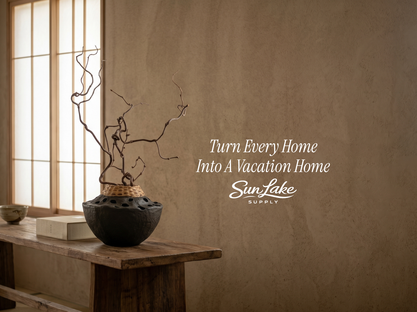 Decorative pot with branches on a wooden table against a textured wall with 'SunLake Supply' text.